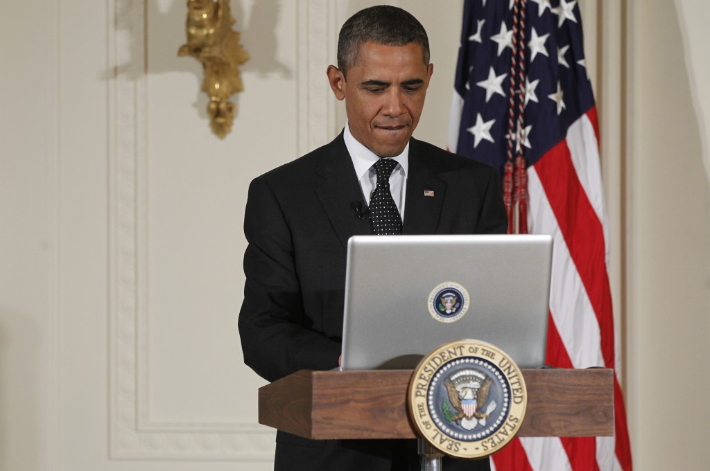 President Barack Obama uses a laptop computer to send a tweet during a " Twitter Town Hall" in the East Room of the White House in Washington, Wednesday, July 6, 2011. (AP Photo/Charles Dharapak)